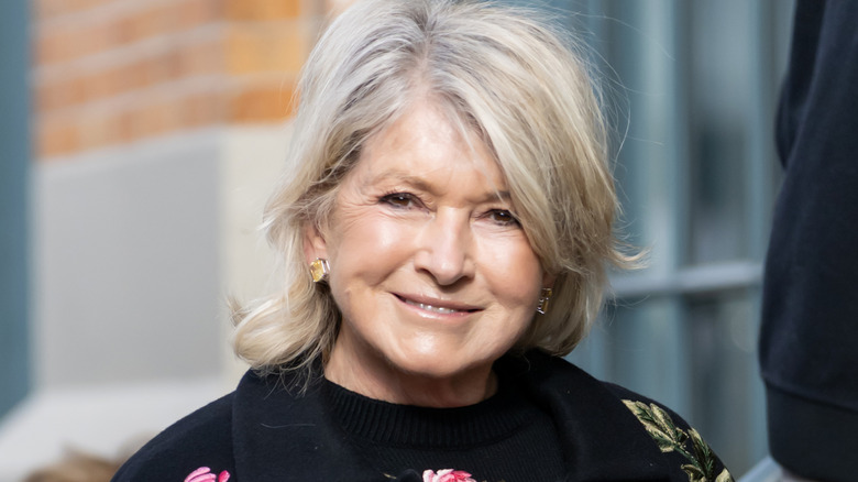 Martha Stewart smiling and wearing a floral sweater set