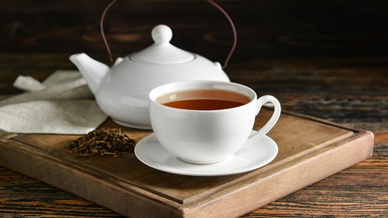 A cup of tea with a teapot