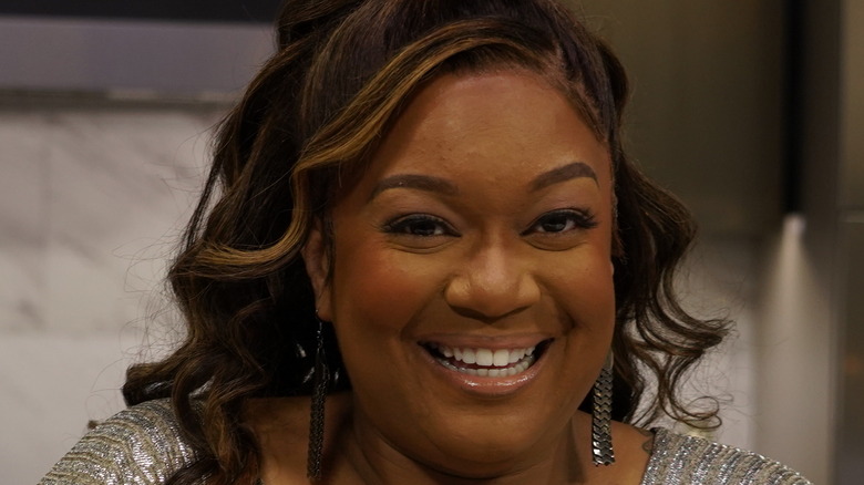 Sunny Anderson smiling in kitchen