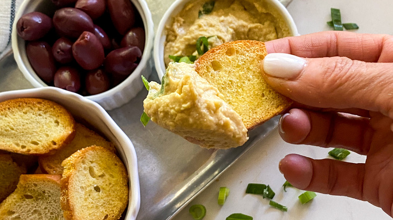 Single bagel chip with hummus