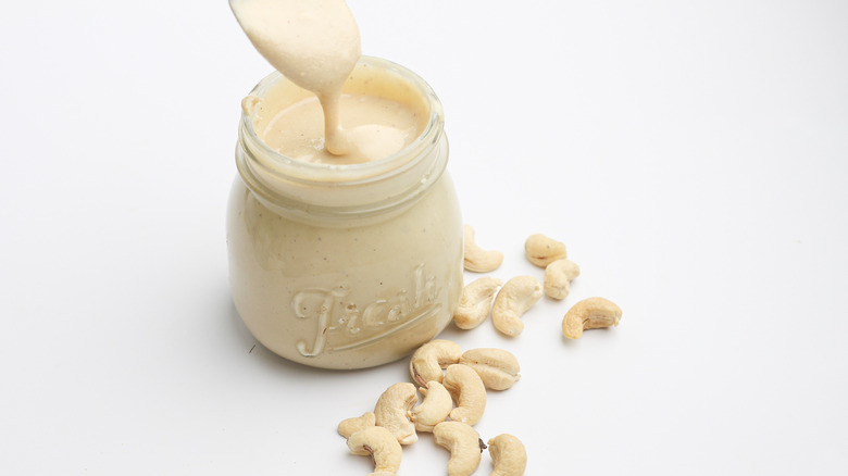 spooning cashew butter from jar  