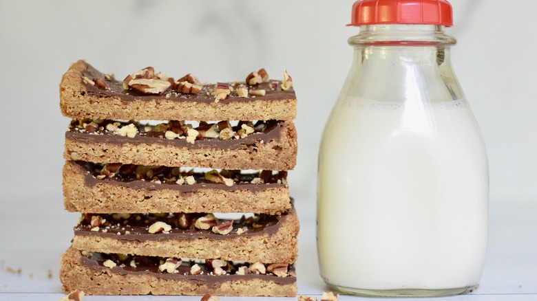 stacked homemade toffee bars with a jar of milk