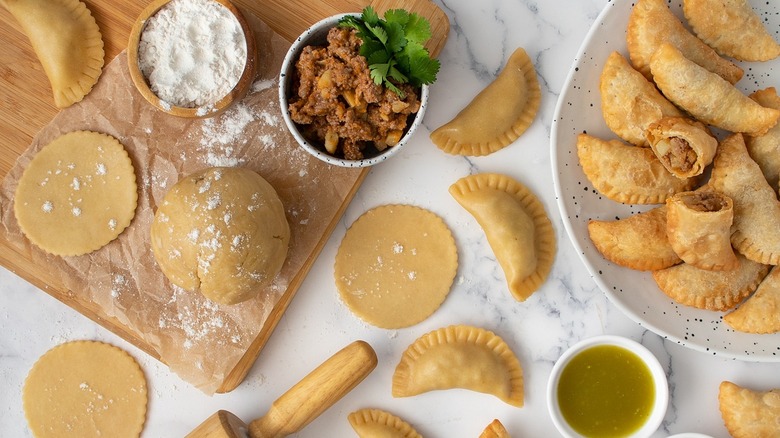 empanadas and ingredients on table