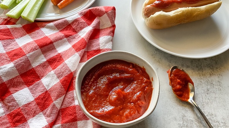 homemade ketchup in bowl and on hotdog