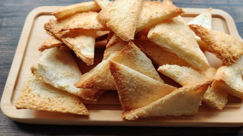 Melba toast on cutting board