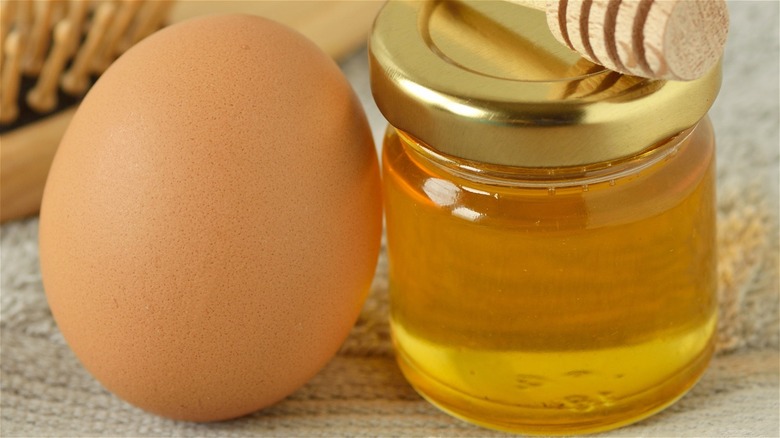 whole egg beside jar of honey