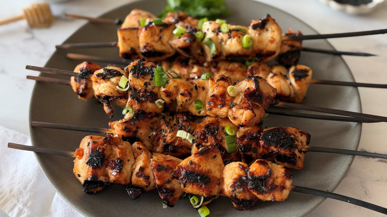 Grilled honey garlic chicken skewers on plate