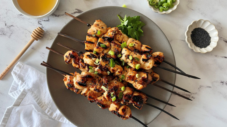 Grilled honey garlic chicken skewers on plate