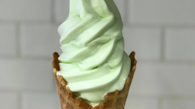 Honeydew ice cream in a cone