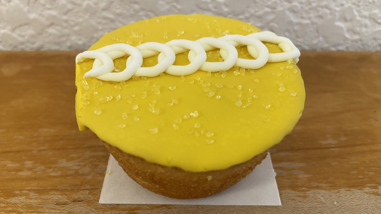 close-up of an unwrapped Hostess Peeps Cupcake with thick frosting, sprinkled sugar, and simple icing design