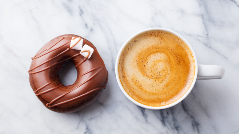 overhead shot of chocolate donut and coffee