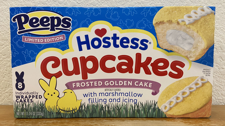 box of Hostess Peeps Cupcakes Frosted Golden Cake on wooden surface