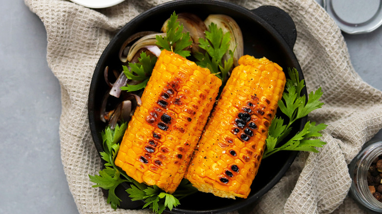 cooked corn on the cob in skillet