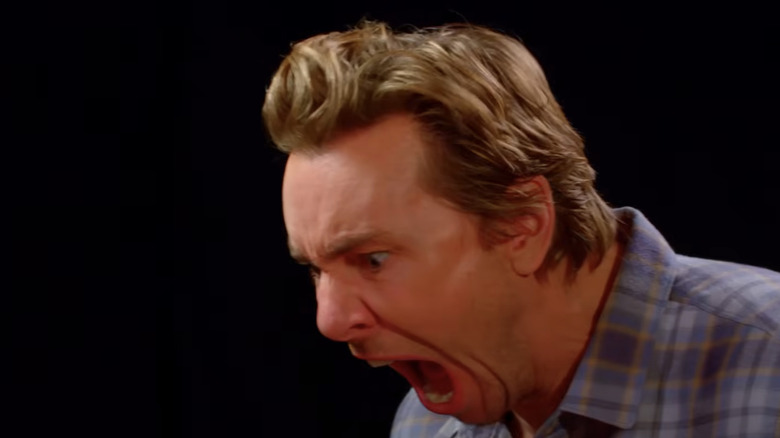 Dax Shepard with mouth open in pain on Hot Ones
