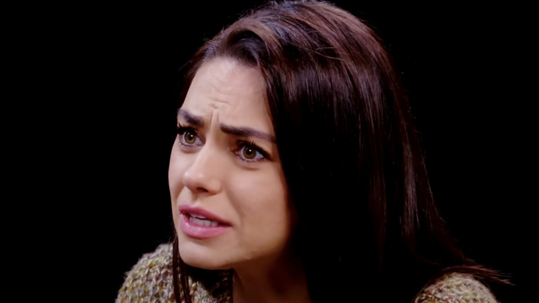 Mila Kunis looking upset on Hot Ones