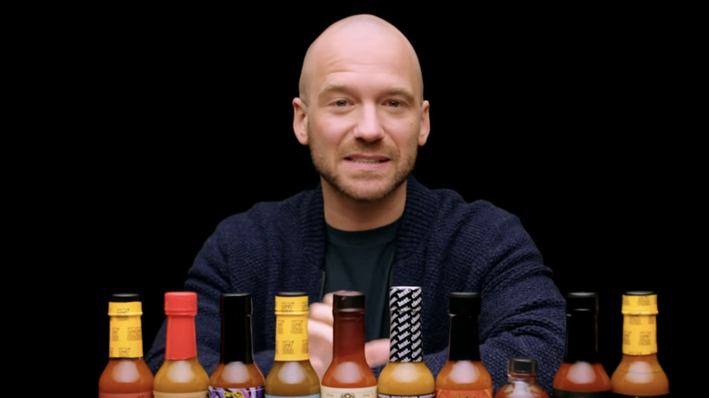 Sean Evans with the season 25 hot sauce lineup