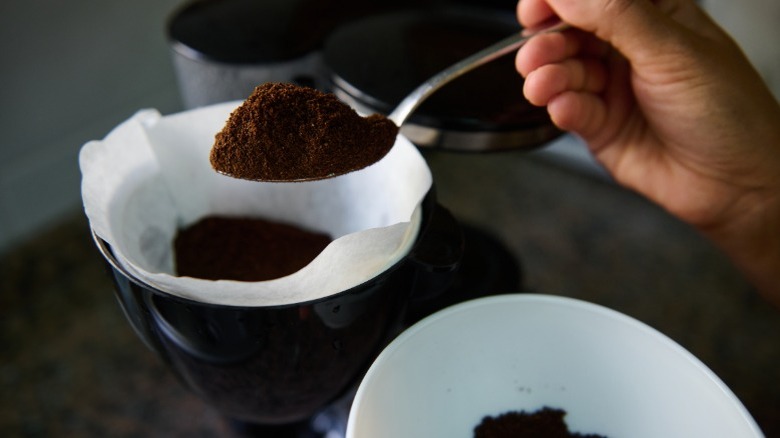 Coffee grounds being put into brewing device