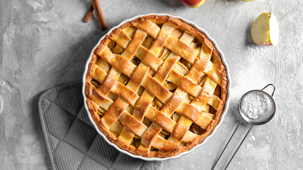 traditional apple pie with lattice crust on plain background