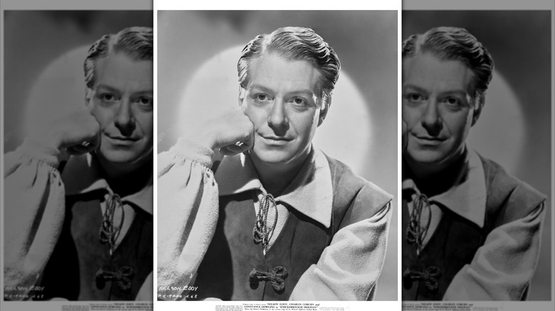 Head shot of actor Nelson Eddy, posing with his face resting against his fist.