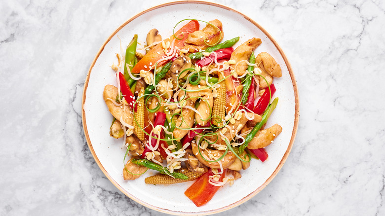 Chop suey in white plate on marble table