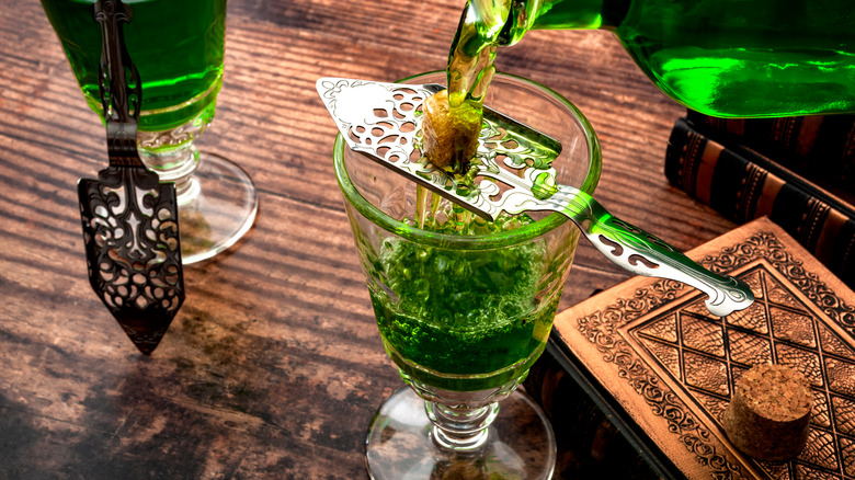 Absinthe being poured over spoon