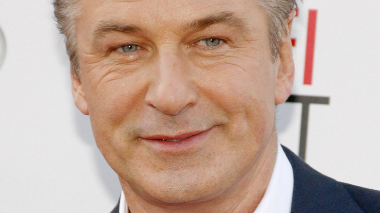 Alec Baldwin with slight smile on the red carpet