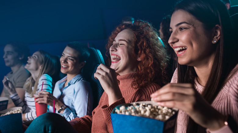 People in cinema eating popcorn