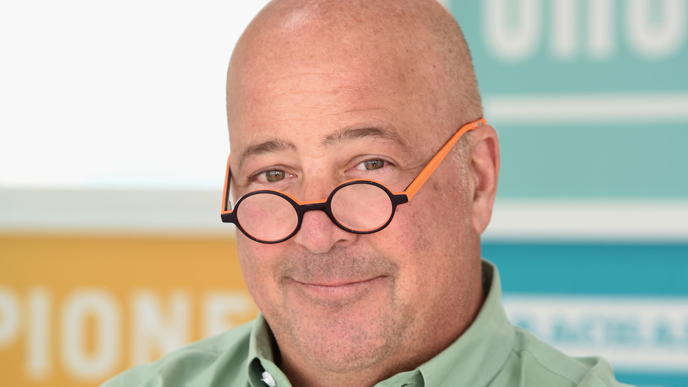 Andrew Zimmern with a half smile 