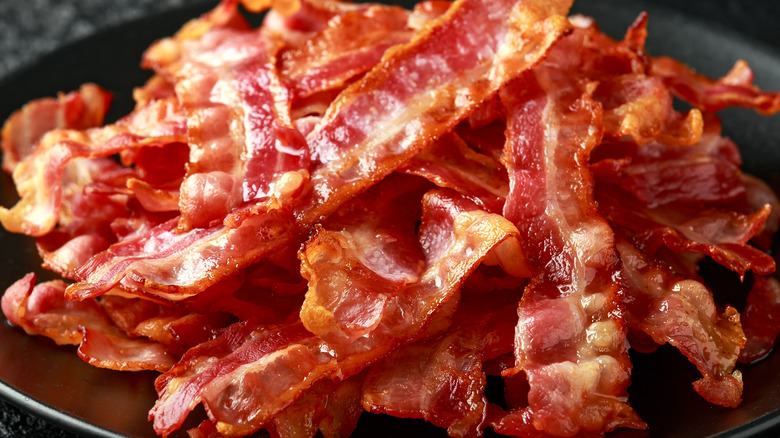 Fried bacon rashers in skillet