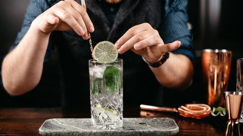 Bartender preparing gin and tonic