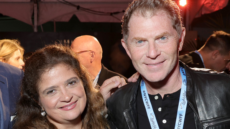 Alex Guarnaschelli and Bobby Flay smiling at event