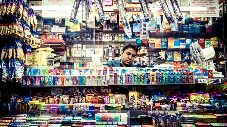 man behind bodega counter
