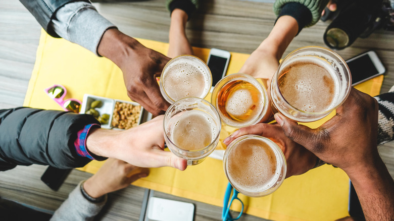 Hands toasting with beer