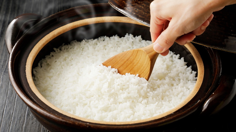 A pot of steaming sushi rice. 