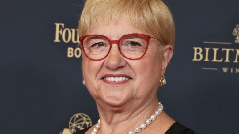 Chef Lidia Bastianich wearing red-framed glasses, earrings, and pearl necklace