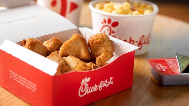 Battered chicken pieces in red Chick-fil-A box
