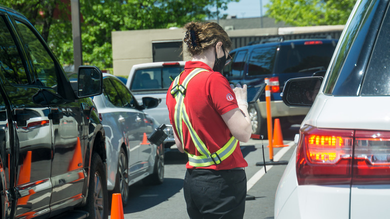 A Chick-fil-A employee taking orders