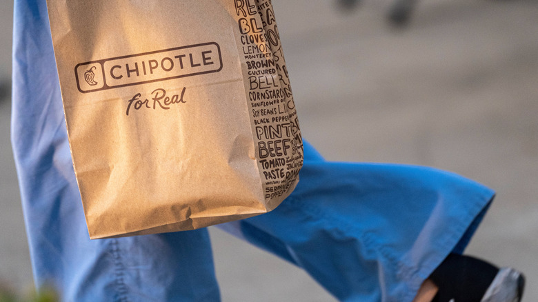 Walking with Chipotle bag