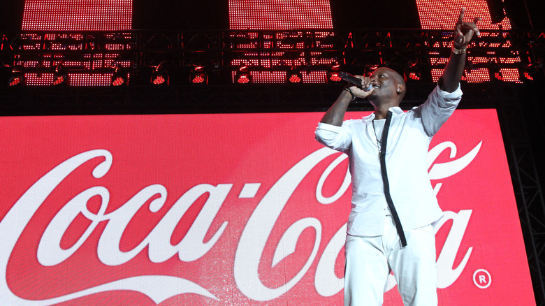 Tyrese Gibson with the Coca-Cola logo in the background