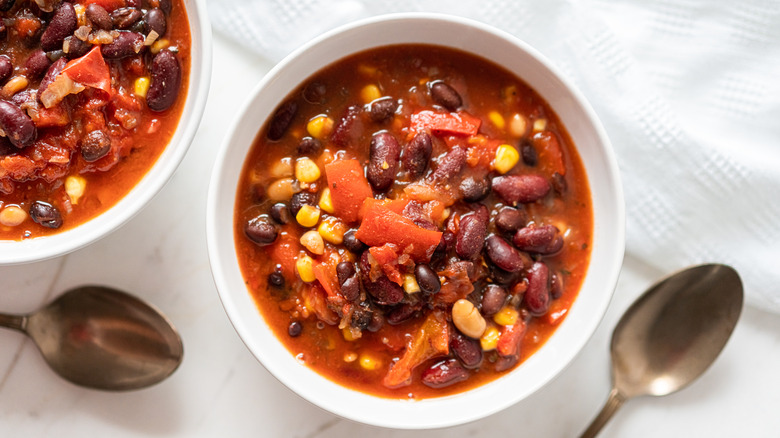 bowl of chili next to a spoon