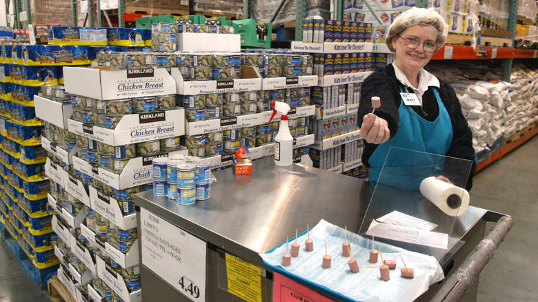 Sample station at Costco with employee offering product