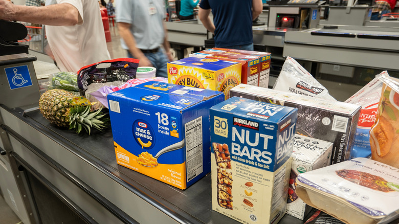 Several grocery items on a checkout conveyor belt at Costco