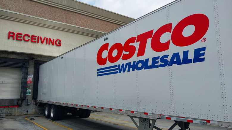 A Costco freight truck loads into a receiving dock