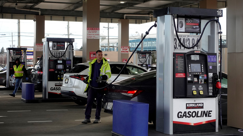 Attendants fill customers' gas tanks at a New Jersey Costco gas station