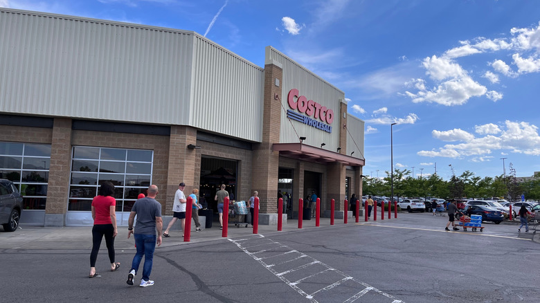 Members walk through parking lot to enter Costco in Salt Lake City