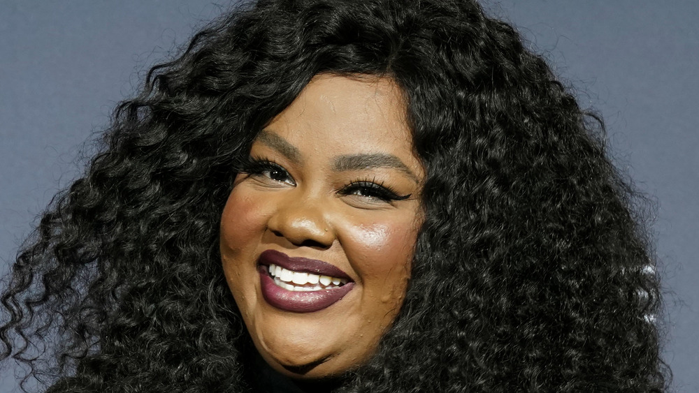 Nicole Byer with red lipstick