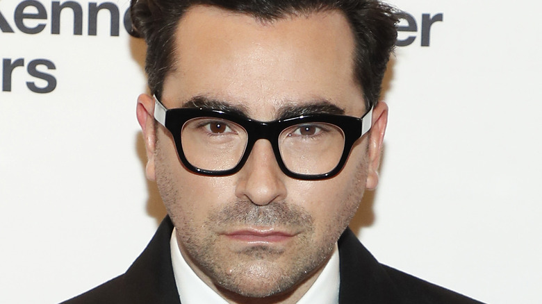 Dan Levy wearing glasses