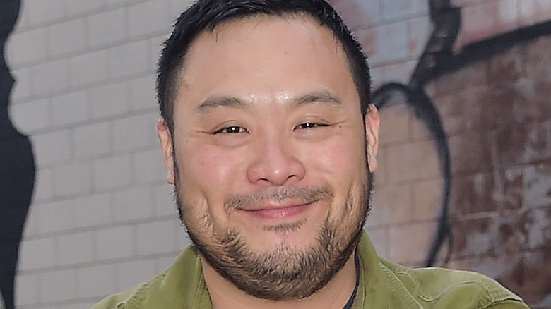 David Chang smiles in green shirt