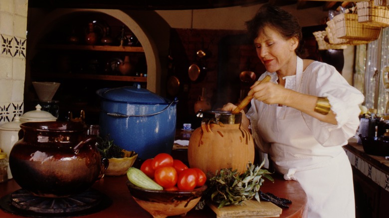 Diana Kennedy working in rustic kitchen