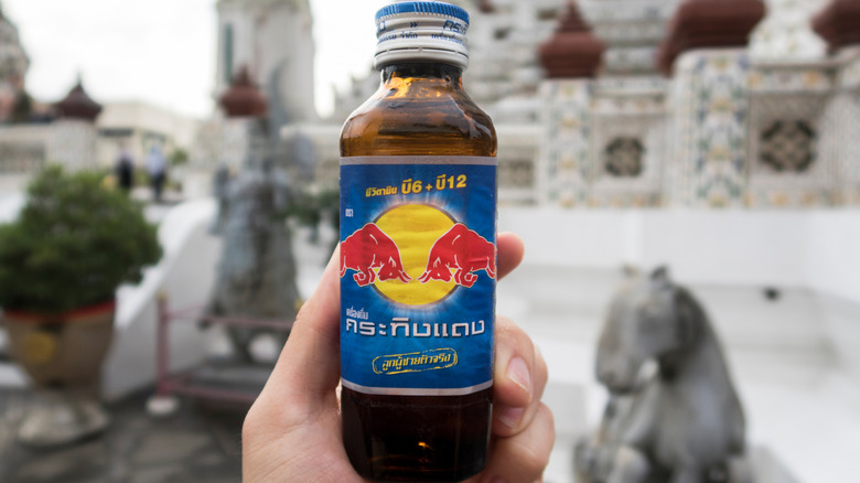Holding bottle of Krating Daeng